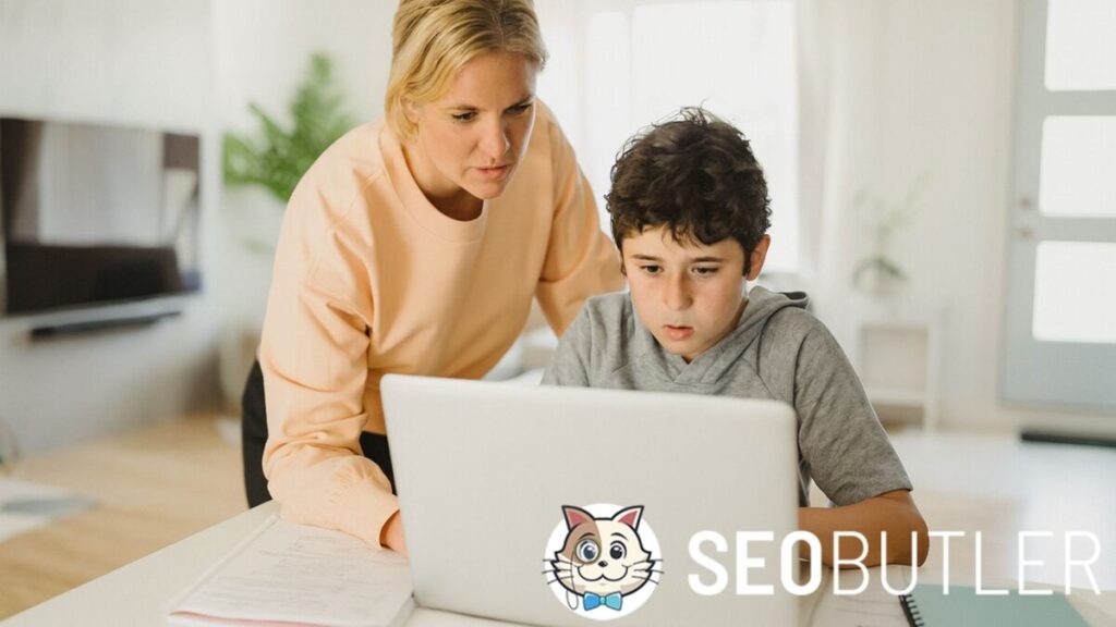 A mother helps her young son use a laptop at home in a bright, cozy living room, with natural light and study materials on the table.